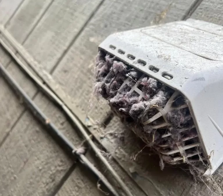 Vent Wise technician performing professional vent cleaning with specialized vacuum