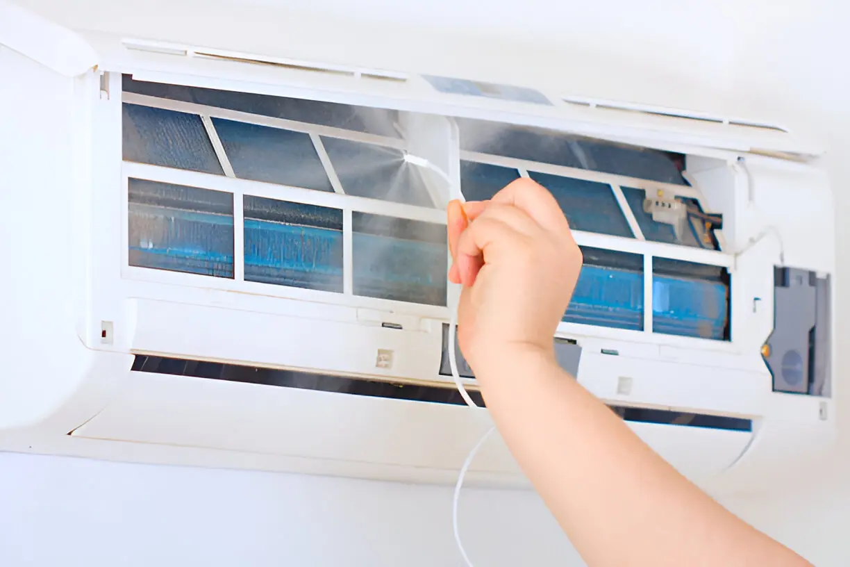 Professional technician performing detailed AC Cleaning Service to remove dust and debris from coils.